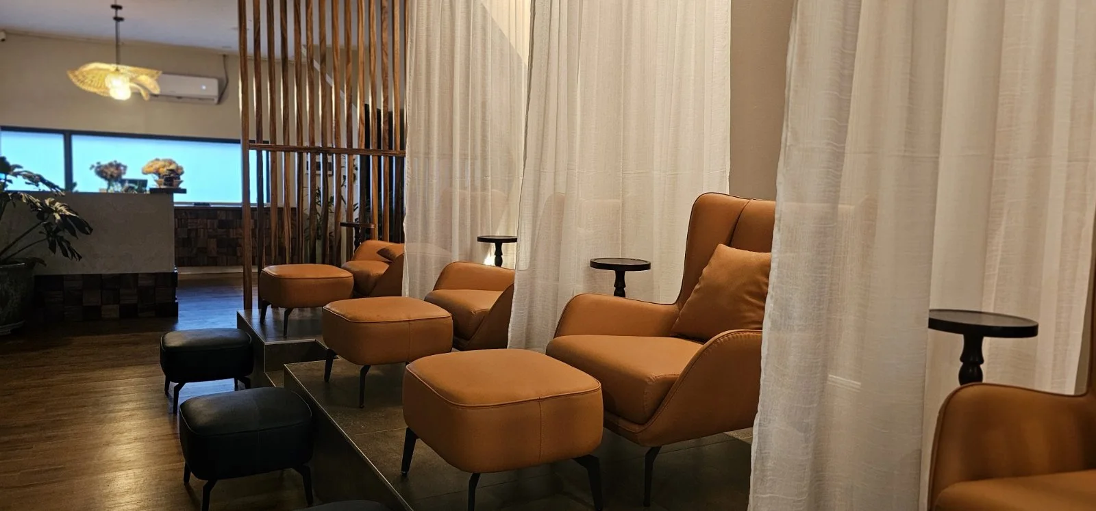 Private lounge chairs divided by sheer curtains