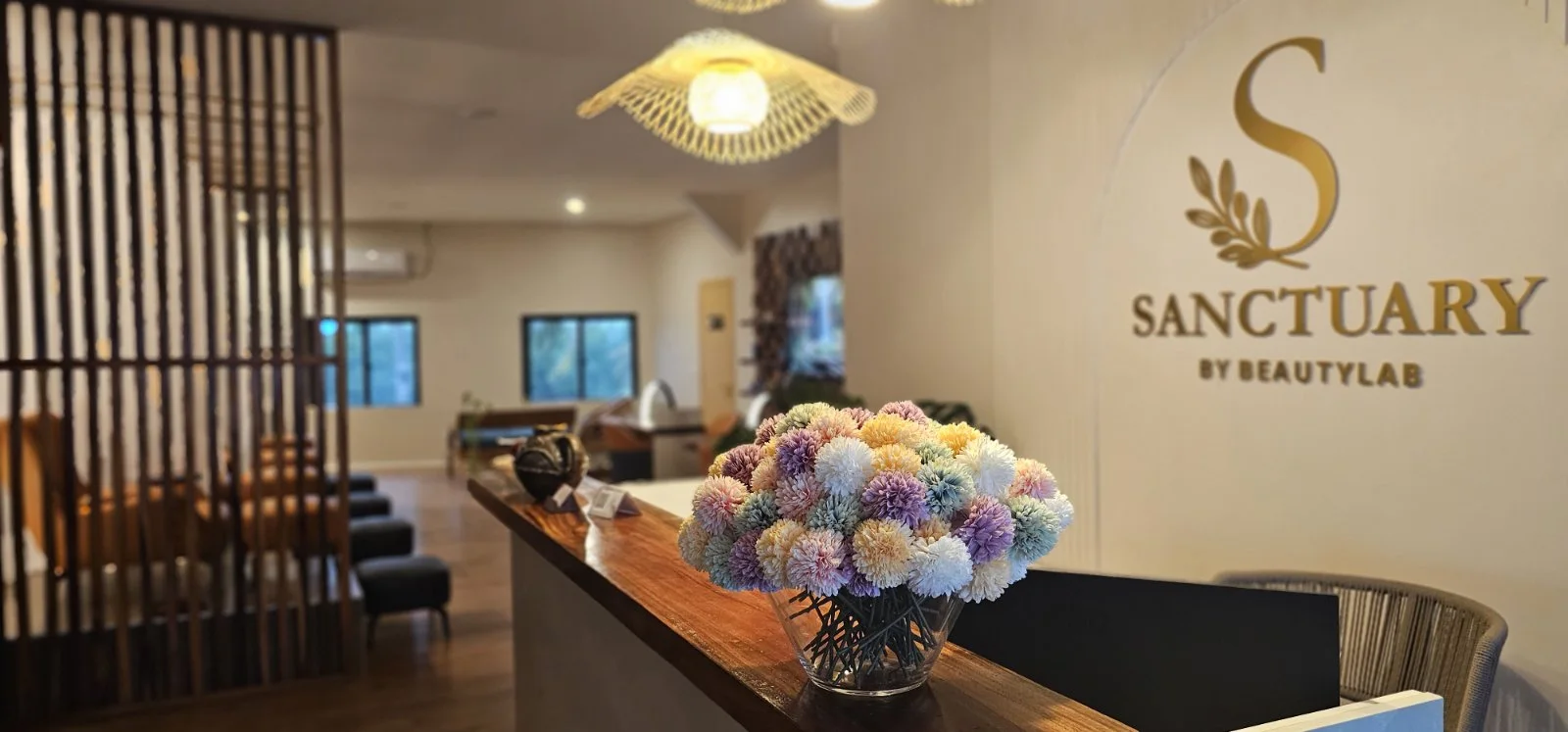 Sanctuary reception with flowers and the gold BeautyLab emblem